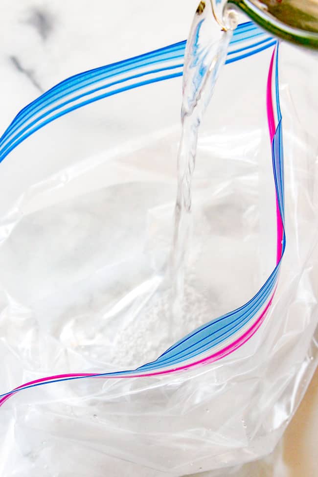 showing how to grill pork tenderloin by adding hot water to a bag to brine pork