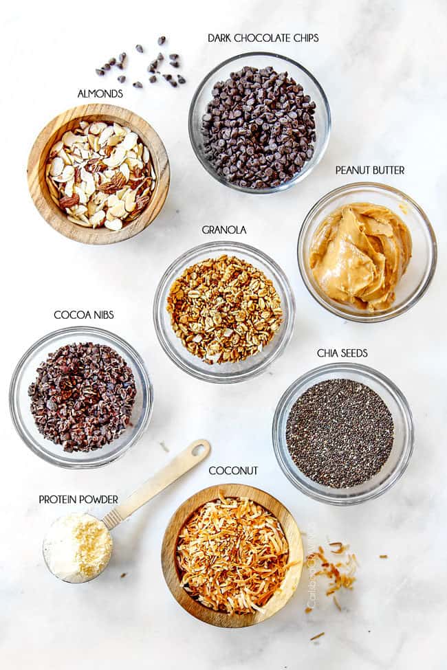 showing how to make acai bowls with toppings of granola, coconut, chia seeds, peanut butter, protein powder, cocoa nibs