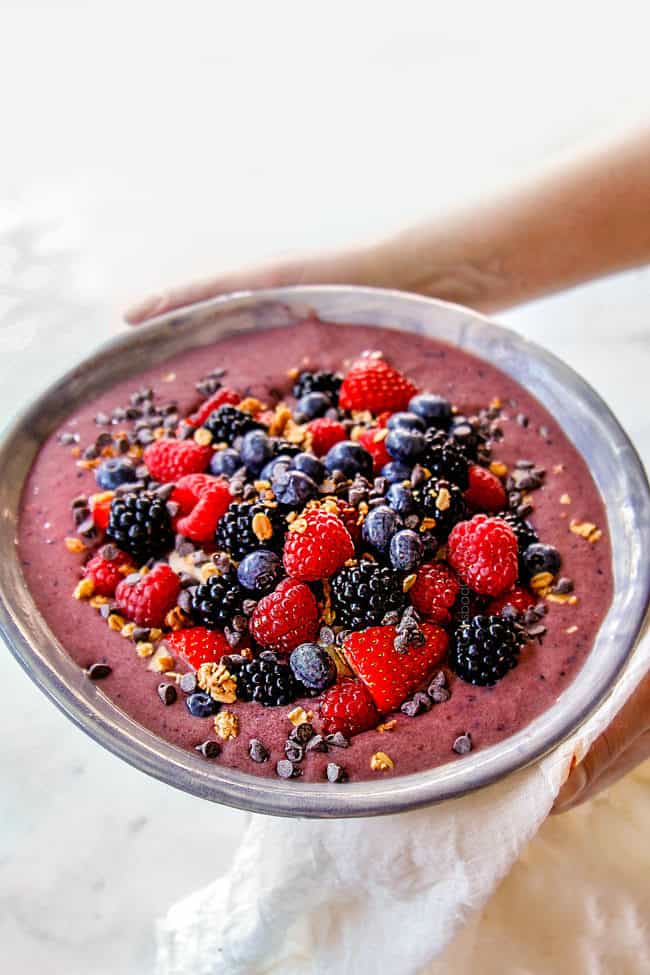side view holding berry acai bowl