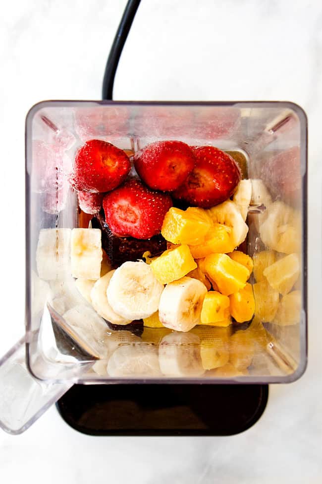 showing how to make acai bowl with pineapple, bananas, strawberries, pineapple juice in blender