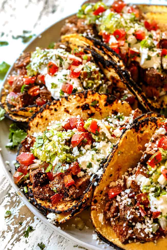side view of easy carne asada taco recipe lined up on a plate