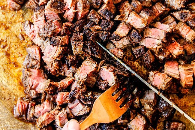 showing how to make carne asada tacos by chopping steak into small pieces