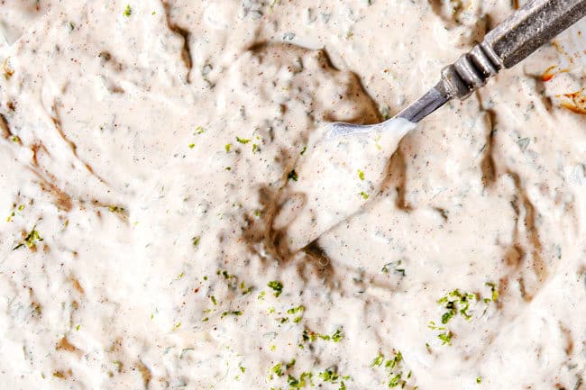 showing how to make elote by mexicano by mixing together mayonnaise, Mexican crema, cilantro, chipotlte powder