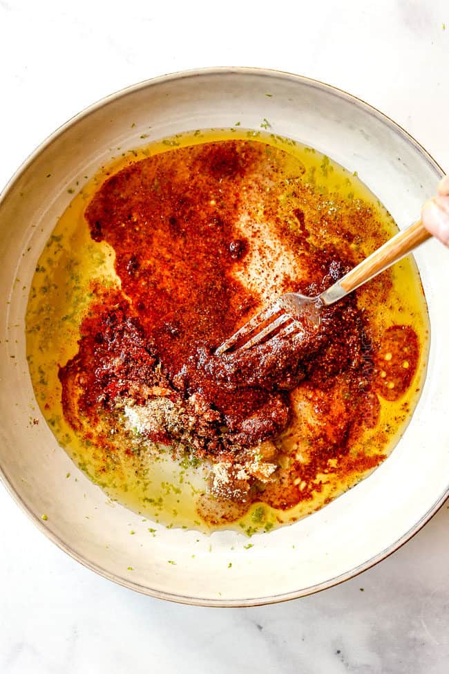 showing how to make fiesta lime chicken by whisking marinade ingredients together