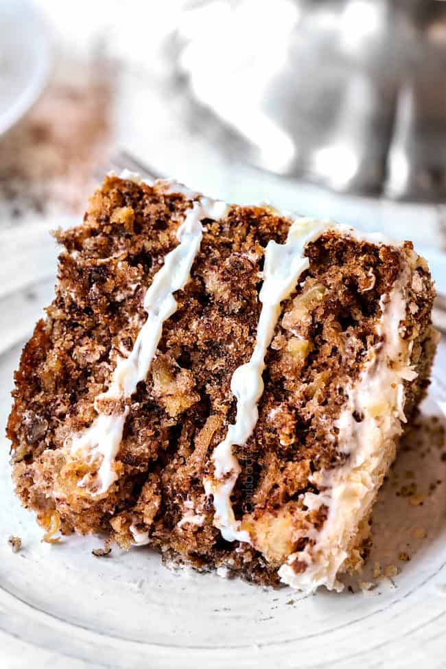 a slice of old fashioned hummingbird cake on a white plate