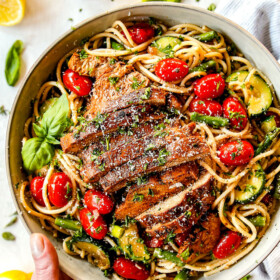 top view of lemon chicken pasta with asparagus in a white bowl