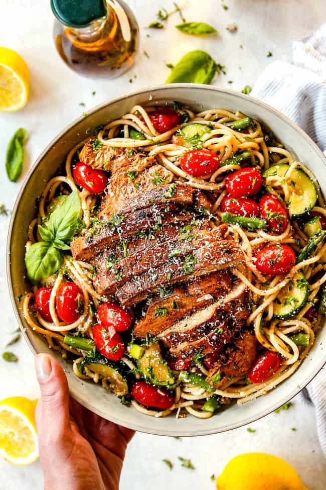 top view of lemon chicken pasta with asparagus in a white bowl