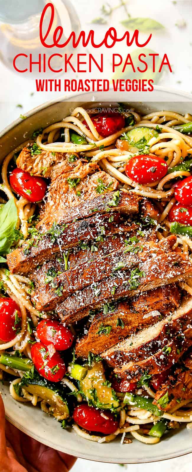 up close top view of lemon chicken pasta with asparagus and Parmesan in a white bowl