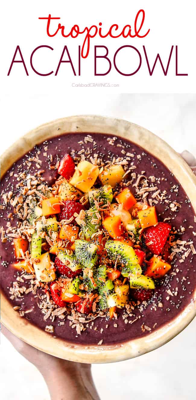 top view of holding a bowl of tropical homemade acai bowl