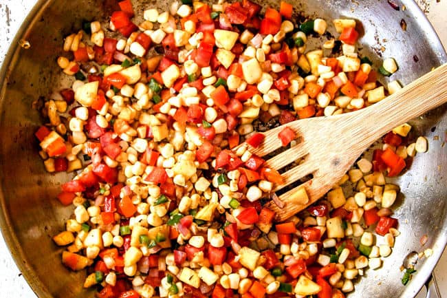 showing how to make stuffed zucchini boats by sauteing corn, bell peppers, onion, jalapeno together for the zucchini boat filling