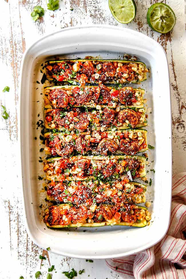 showing how to make stuffed zucchini boats recipe by filling baked zucchini with filling