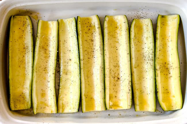 showing how to make zucchini boats by lining zucchini boats in a 9x13 baking dish