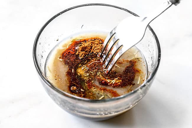 showing how to roast butternut squash by whisking spices together