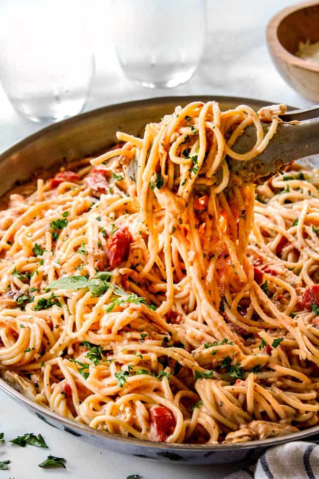 tongs picking up easy chicken spaghetti recipe