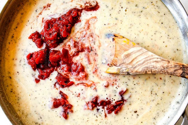 showing how to make creamy chicken spaghetti by adding Rotel tomatoes to sauce