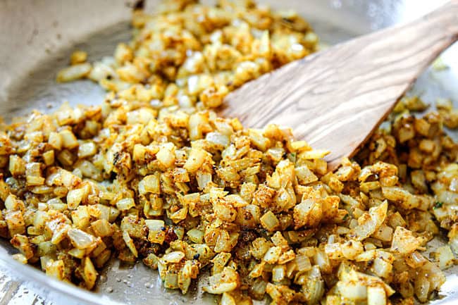 showing how to make pineapple fried rice recipe by cooking onions with curry powdr