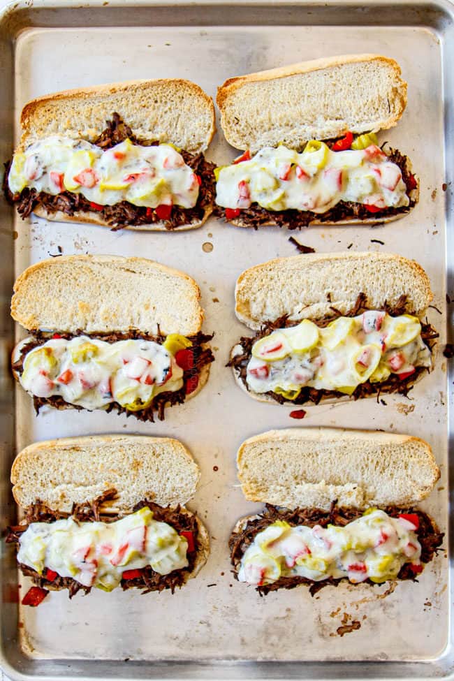 showing how to make Crock Pot Italian Beef sandwiches by melting provolone on roast beef