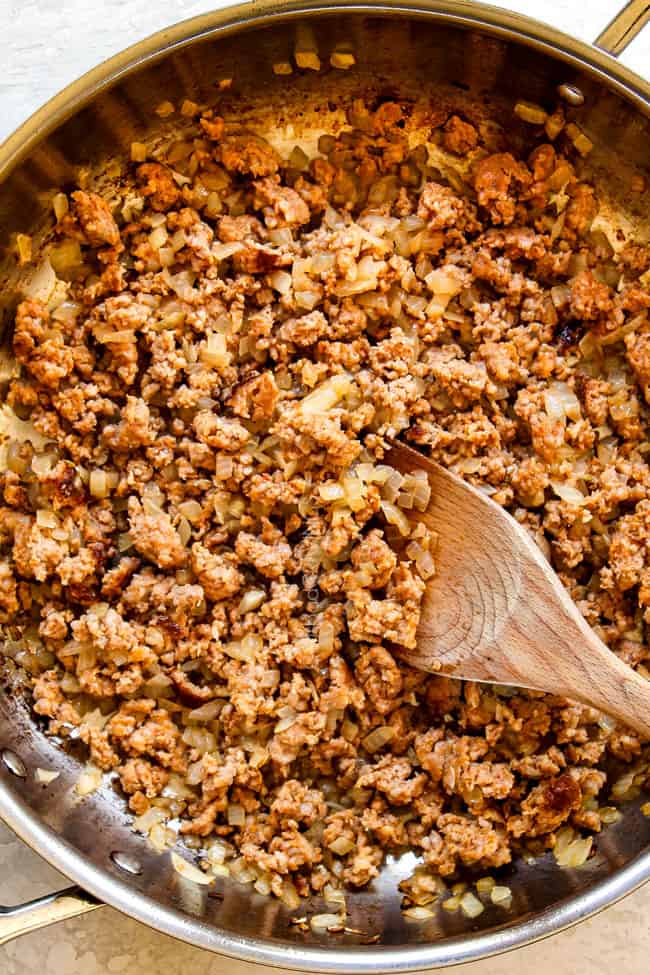 showing how to make rigatoni by cooking sausage and onions in a skillet