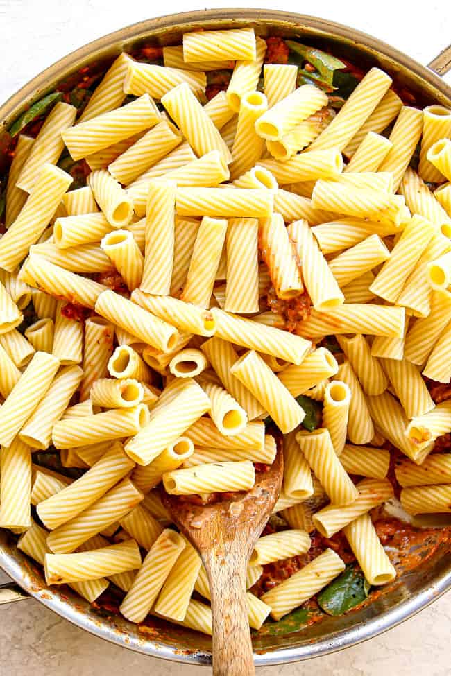 showing how to make rigatoni recipe by adding rigatoni