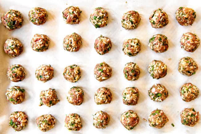 showing how to make meatballs for Albondigas Soup by forming meatballs and placing them on a baking sheet