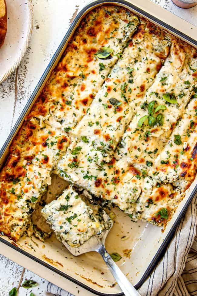 showing how to serve white chicken lasagna with a spatula