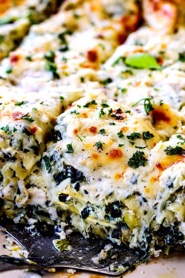 up close of a spatula scooping up white lasagna