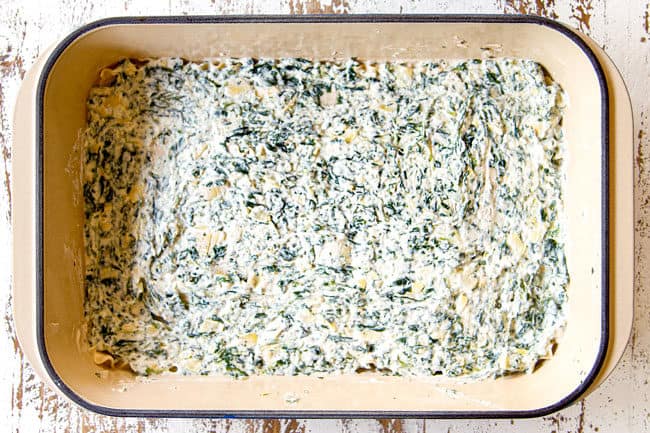showing how to make chicken alfredo lasagna by layering a 9x13 with ricotta with artichokes, spinach and Parmesan