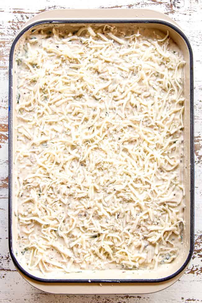 showing how to make best chicken lasagna by finish layering with a top layer of mozzarella cheese