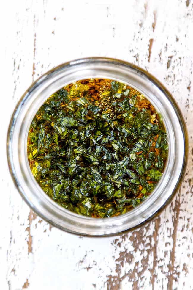 showing how to make green bean and tomato salad recipe by adding basil to salad dressing