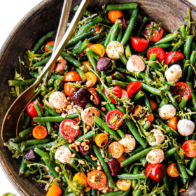 top view of green bean and tomato salad in a wood bowl