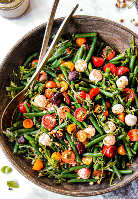 top view of green bean and tomato salad in a wood bowl