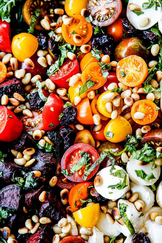 up close of green bean and tomato salad with pine nuts and basil