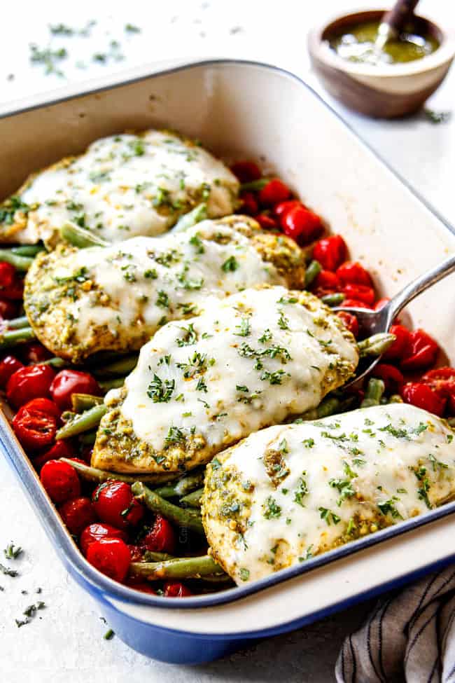 serving pesto chicken bake with mozzarella cheese