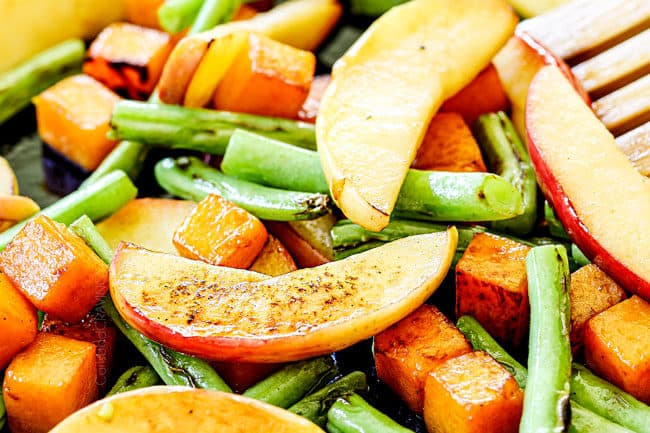 showing how to make pan seared pork chops with apples by cooking apples in a cast iron skillet