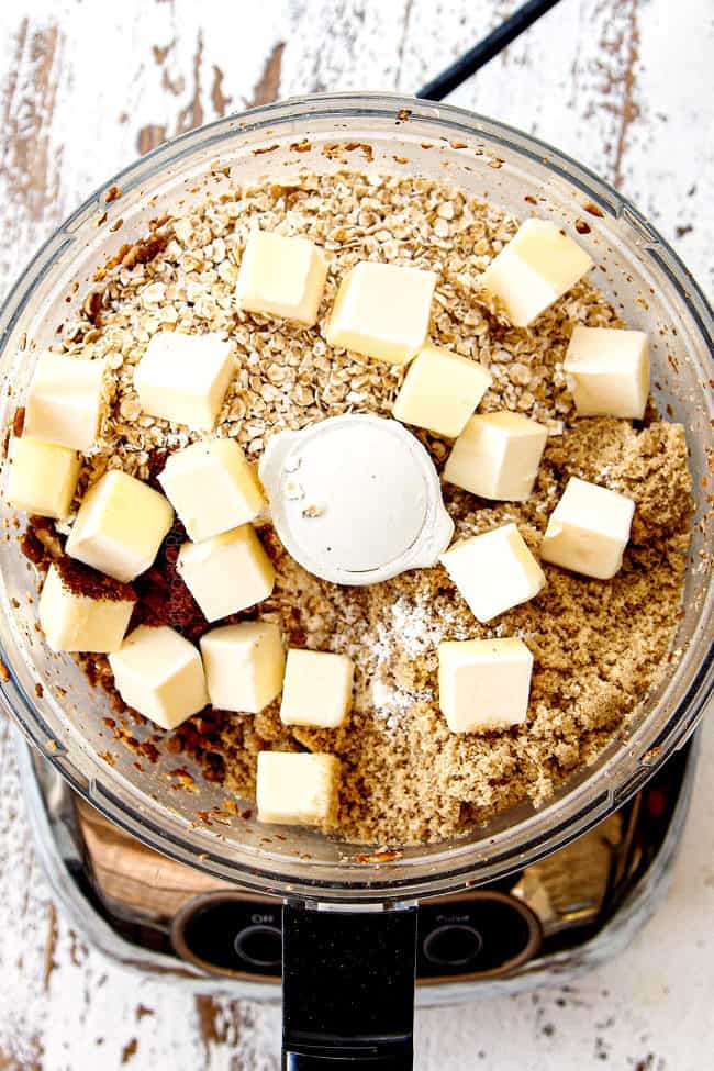 showing how to make best pumpkin cheesecake bars by making streusel in food processor with flour, butter, sugar and pecans