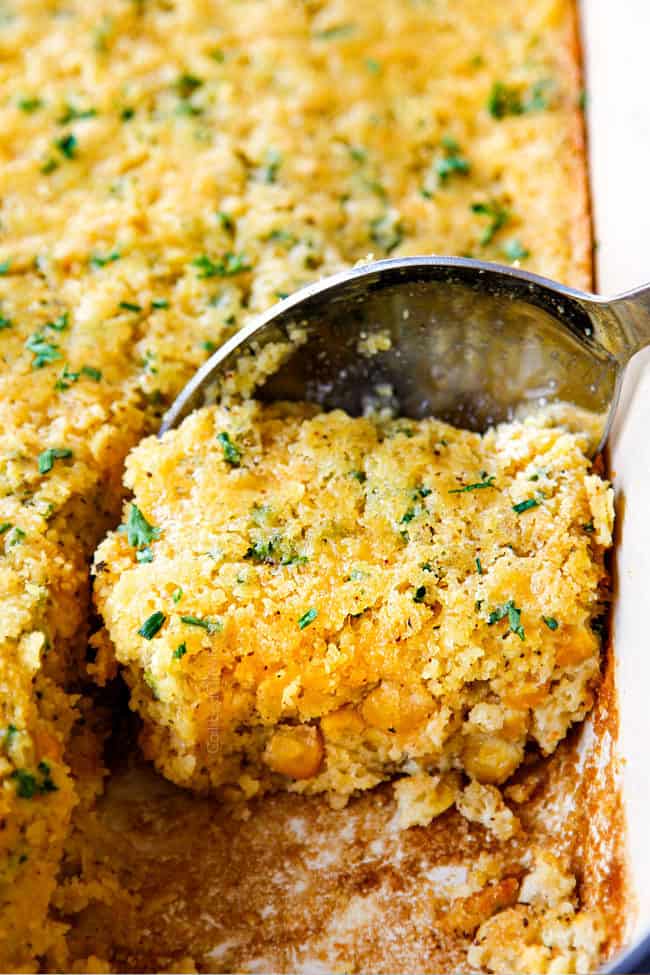 a spoon scooping up a piece of cream corn casserole