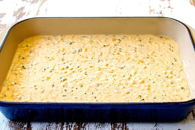 showing how to make corn casserole recipe by pouring batter into a 9x13 baking dish