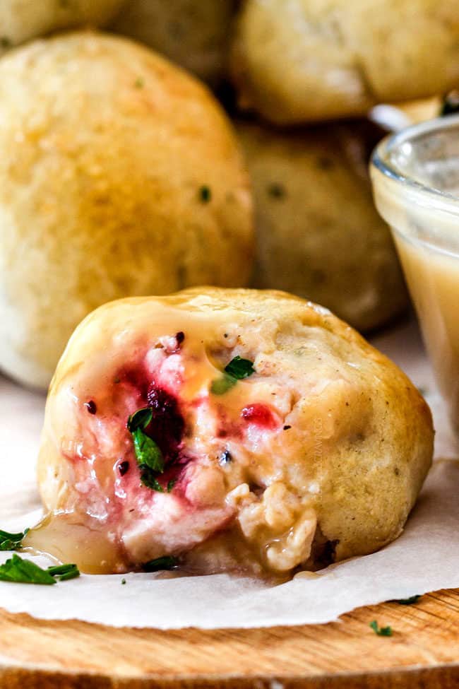 up close of a roll stuffed with leftover turkey, mashed potatoes, cranberry sauce