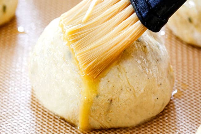 showing how to make leftover turkey recipe by brushing egg over dough