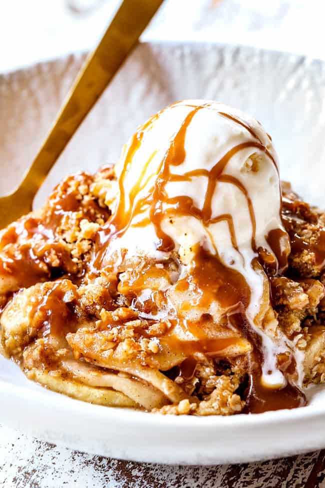 up close side view of showing how to serve best apple crisp with oatmeal with vanilla ice cream and caramel