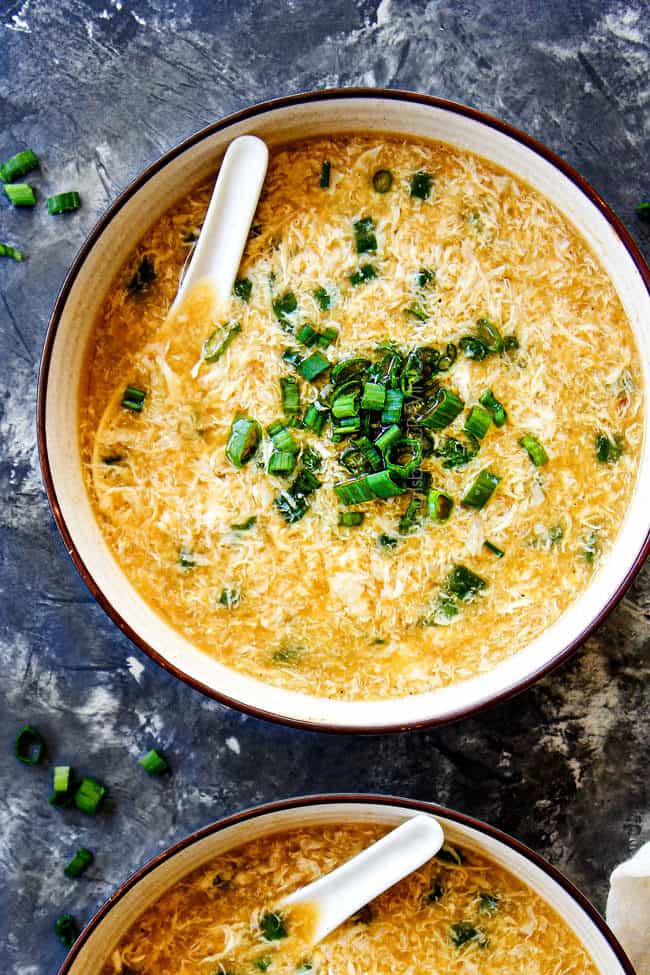 showing how to make Egg Drop Soup by drizzling eggs into stock in a saucepan