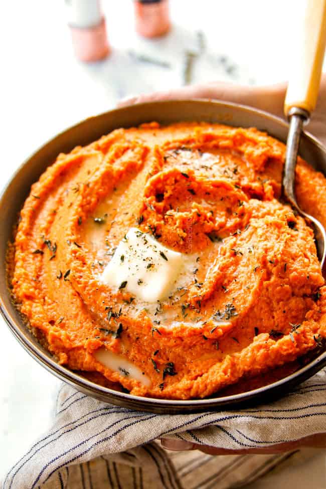two hands holding best mashed sweet potato recipe