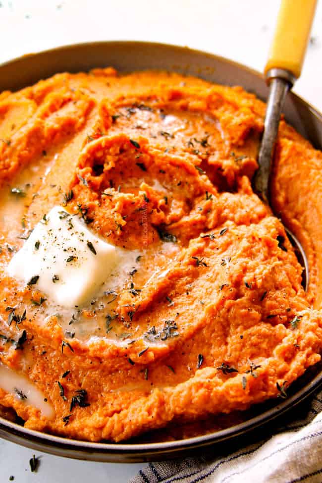 butter melting in a bowl of baked mashed sweet potatoes