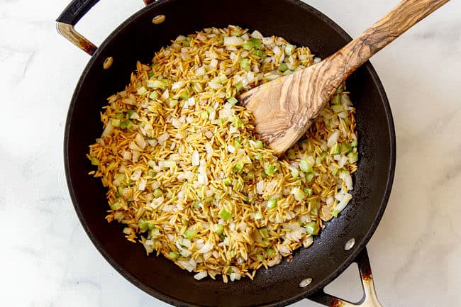showing how to make rice pilaf by toasting orzo with onions