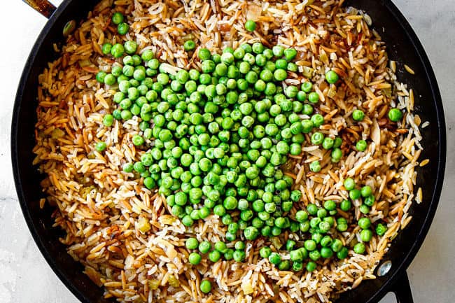 showing how to make rice pilaf by adding peas and letting pilaf rest