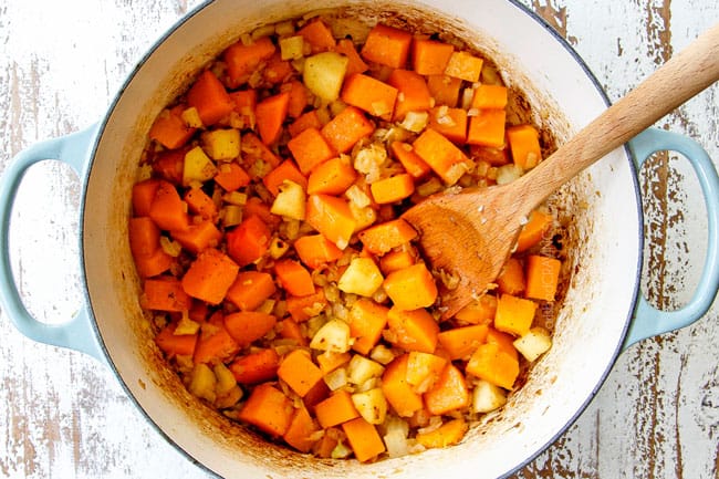 showing how to make butternut squash soup by cooking butternut squash, onion, fennel, garlic and apple in a Dutch oven until soft