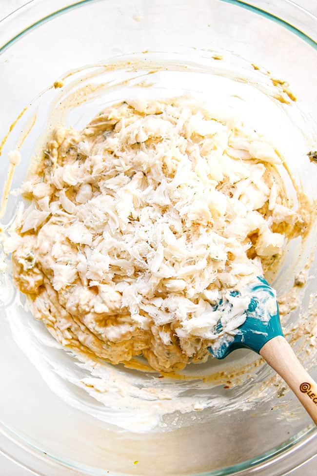 showing how to make crab rangoon by adding crab meat to fiilling