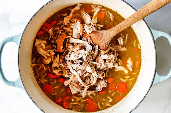 showing how to make chicken noodle soup by adding shredded chicken and egg noodles to soup