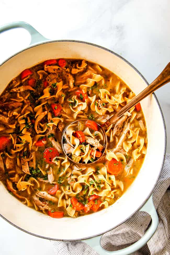 showing how to serve chicken noodle soup by ladling soup