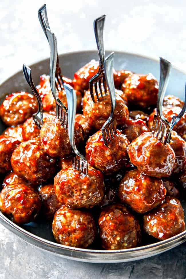 a bowl of easy cocktail meatballs with toothpicks sticking in them ready to serve